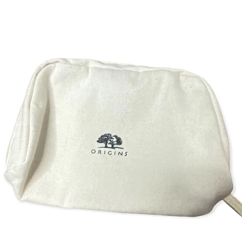 Origins cream canvas make up bag with zip closure small marks inside